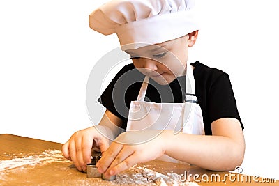 Young boy making gingerbread. Kid cutting cookies with molds, baking it for Christmas table. Isolated on white Stock Photo