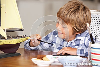 Young boy making model ship Stock Photo