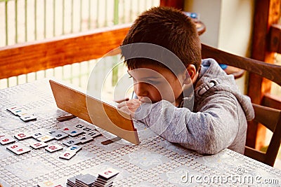 Young boy playing Rummy Stock Photo