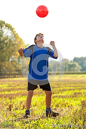 Young boy playing with soccer ball outdoors. Stock Photo