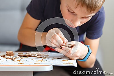 Young boy playing with eco wooden constructor Stock Photo