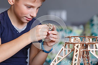 Young boy playing with eco wooden constructor Stock Photo