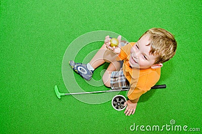 Young boy plays mini golf Stock Photo