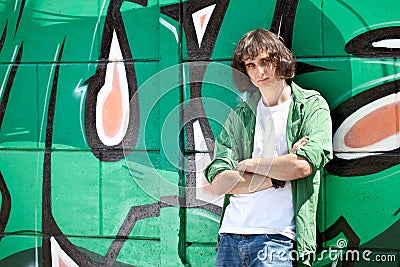 Young boy posing against a graffiti wall Editorial Stock Photo