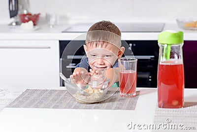 Young Boy Pushing Away Bowl of Breakfast Cereal Stock Photo