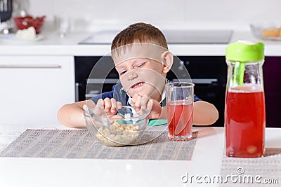Young Boy Pushing Away Bowl of Breakfast Cereal Stock Photo