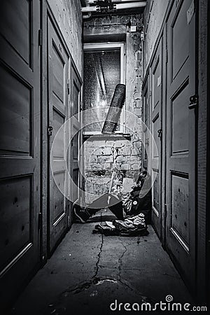 A young boy sitting alone on a floor Stock Photo