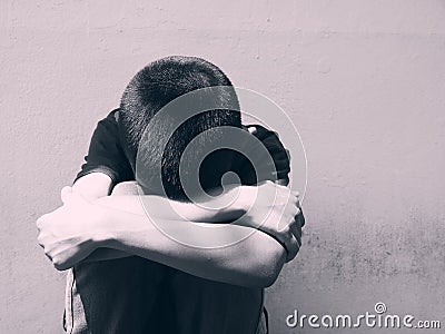 Young boy sitting alone and sad at the school. Stock Photo