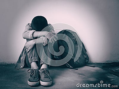 Young boy sitting alone and sad at the school. Stock Photo