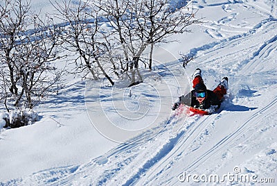 Young boy sledding Stock Photo