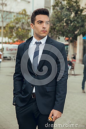 Boy in suit smoking with vaper Stock Photo