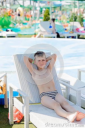 Young boy in a swimsuit on a shelf by the pool Stock Photo