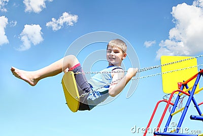 Young boy on swing Stock Photo