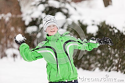 Young boy throwing snowballs Stock Photo