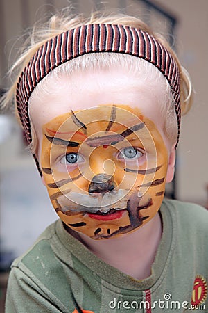 Young boy or toddler covered in Tiger face paint Stock Photo
