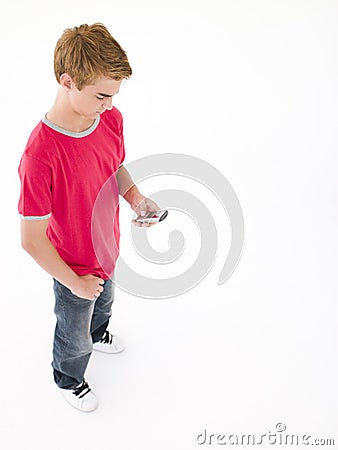 Young boy using cellular phone Stock Photo