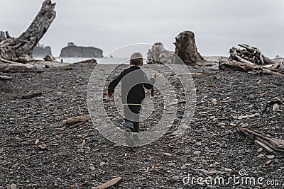 Young boy walking onto Rialto Beach in Olympic National Park Stock Photo
