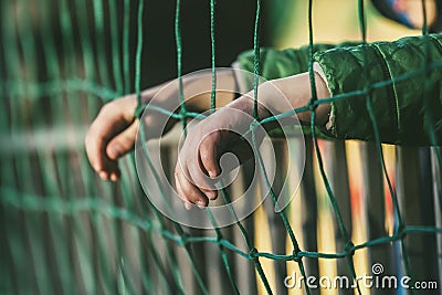 Young boy watches a sports game from the bleachers with a soccer Stock Photo