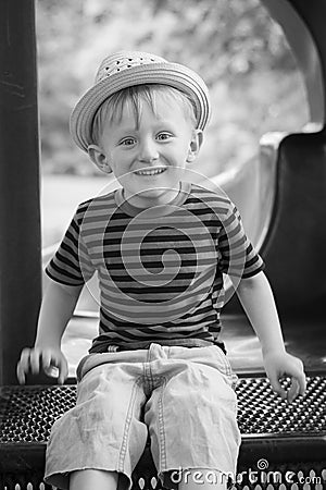 Young boy wearing a fedora at the park Stock Photo