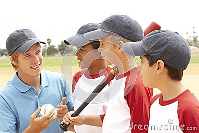 Young Boys In Baseball Team With Coach Stock Photo