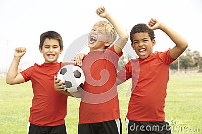 Young Boys In Football Team Celebrating Stock Photo