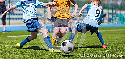 Young boys kids kicking soccer football on the sports field. Editorial Stock Photo
