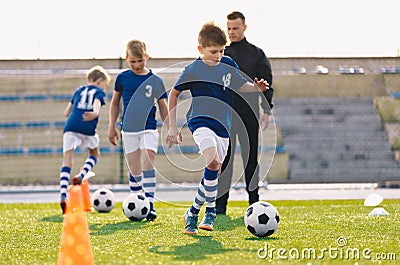 Young Boys in Sports Soccer Club on Training Unit. Kids Improve Soccer Skills on Natural Turf Grass Pitch Stock Photo