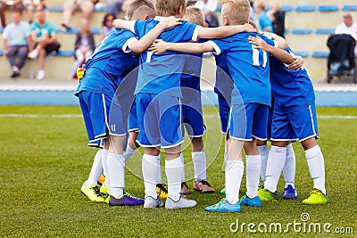 Young boys sports team on stadium. Football players in sportswear motivating before the match Editorial Stock Photo