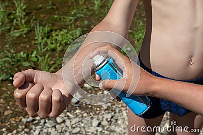 young boys use mosquito spray. People spraying insect repellent on skin outdoor. insect bite protection Stock Photo