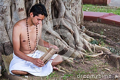 Young brahmin reads scripture Stock Photo