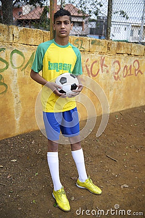 Young Brazilian Football Player Holds Soccer Ball Stock Photo