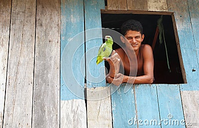Young brazilian and his parrot Editorial Stock Photo