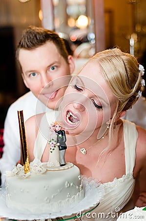 Young bride is going to bite her cake Stock Photo