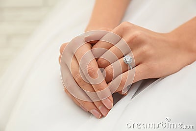 Young bride wearing beautiful engagement ring, closeup Stock Photo