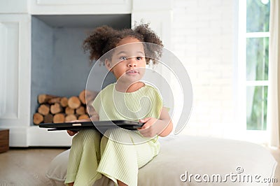 A young bright cute little girl with her trusty tablet that makes her happy Stock Photo