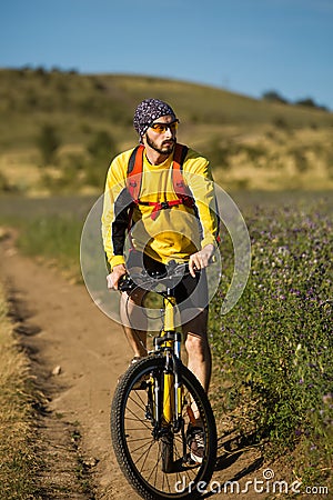 Young bright man on mountain bike Stock Photo