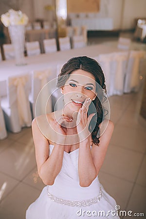 A young brunette bride poses for the camera. An emotional smiling bride Stock Photo