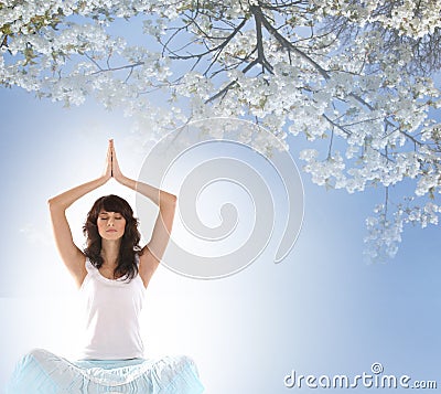 A young brunette Caucasian meditating woman Stock Photo