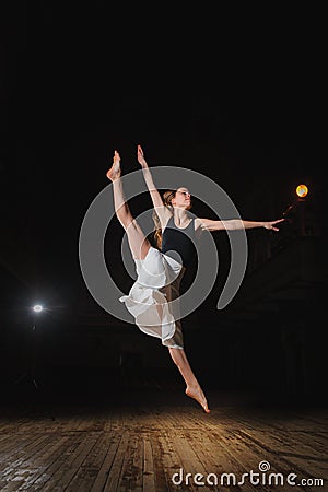 Young brunette dancer girl in split jump Stock Photo