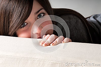 Young brunette female lean out sofa playful Stock Photo