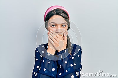 Young brunette girl wearing elegant look shocked covering mouth with hands for mistake Stock Photo