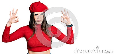 Young brunette teenager doing excellent gesture with hand skeptic and nervous, frowning upset because of problem Stock Photo
