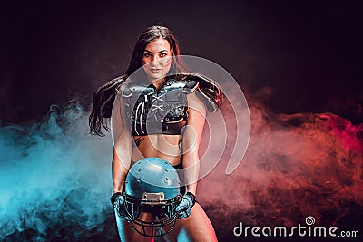 Young brunette wearing sexy uniform of rugby football player posing Stock Photo