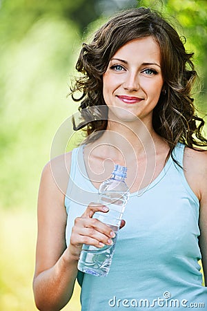 Young brunette woman holding bottle Stock Photo