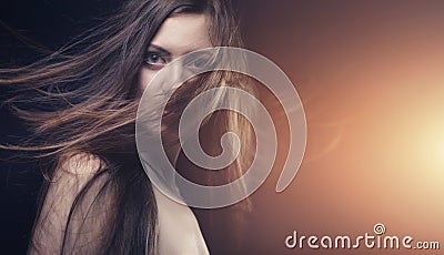 Young brunette woman with long flying hair Stock Photo