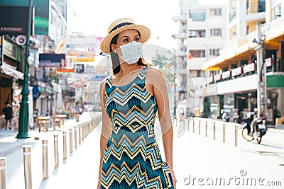 20s Hispanic Brunette woman in a protective mask wear summer sleeveless summ dress in Asia. Stock Photo