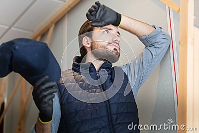 young builder tired working Stock Photo
