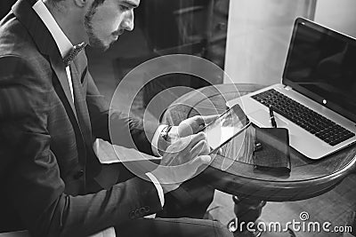 Young businesman working at cafe, using mobile phone Stock Photo