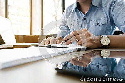 Young business executive work in modern office on notebook Stock Photo