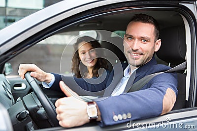 Young business man couple in their brand new car Stock Photo